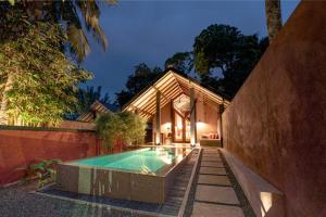 a house with a swimming pool in front of a house at Nisala Villas in Hikkaduwa