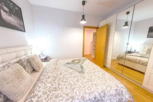 a bedroom with a large bed and a mirror at Old Town Spacious Apartment in Bucharest