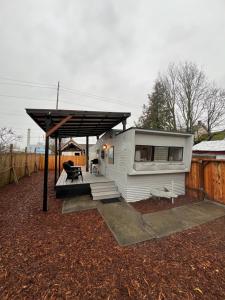 a small white house with awning on a yard at Cozy Guest House in Bellingham