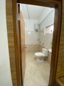 a bathroom with a toilet and a sink at Ahasa Bacardi in Hyderabad