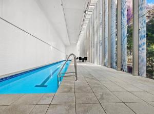 a swimming pool in the side of a building at Luxury City Center King Bed Apartment and Study in Brisbane