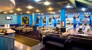 a dining room with tables and a bowling alley at Alexandrovsky Garden in Nizhny Novgorod