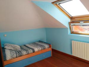 a small room with two beds in a attic at Ático cerca de la playa in Castro-Urdiales