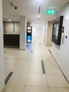 an empty hallway in a hospital with a sign on the wall at Private bedroom with Burj View in Dubai