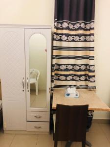 a dressing room with a table and a mirror at Private bedroom with Burj View in Dubai