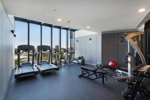 a gym with a bunch of cardio equipment in a building at 1 BRM, Sea View, Newly Renovated, Next to Crown in Melbourne