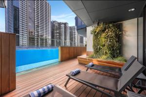 a balcony with a swimming pool on a building at 1 BRM, Sea View, Newly Renovated, Next to Crown in Melbourne