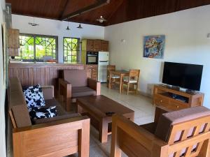 a living room filled with furniture and a flat screen tv at VILLABLANCA in Nosy Be