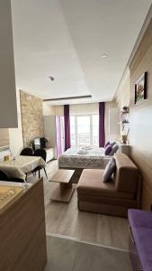a large room with a bed and a couch and a room with a couch at Apartman Vana in Kopaonik