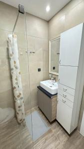 y baño con lavabo y ducha. en Apartman Vana en Kopaonik