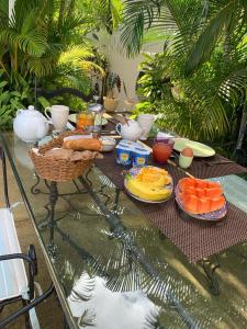 a table with food on top of a table with fruit at JayKay_PrivateRoom_FlicEnFlac in Flic-en-Flac