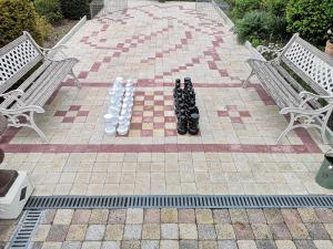 a chess set on a checker board between two benches at Gite du Chevalier du fort st ours in Loches