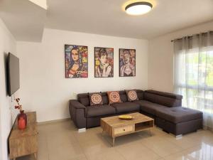 a living room with a couch and a coffee table at arie apartment in Eilat