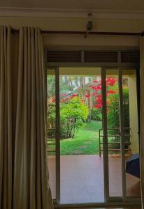 a sliding glass door with a view of a garden at House in Kampala in Kampala