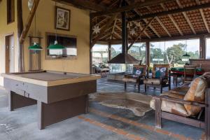 a large room with a pool table in it at Apartamento na Fazenda c/ Piscina Termica in Palmeira