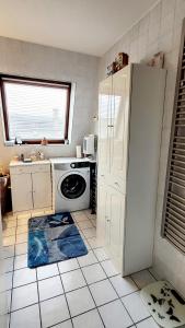 a kitchen with a white refrigerator and a dishwasher at Cosy. 10mn du centre et de la gare. Garage gratuit in Colmar