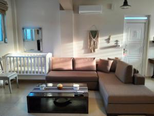 a living room with a couch and a coffee table at Studio Melissi Korinthias in Melíssion
