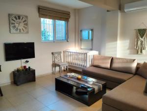 a living room with a couch and a coffee table at Studio Melissi Korinthias in Melíssion