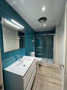 a bathroom with a white sink and a toilet at SeaHomes Vacations - NAUTIC MARITIME Apt in Blanes