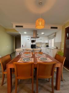 a dining room with a wooden table and chairs at SeaHomes Vacations - NAUTIC MARITIME Apt in Blanes