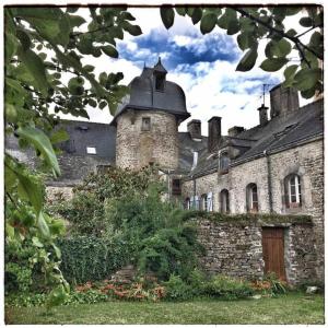 an old brick building with a tower on top of it at Le gite des bulles, parking gratuit privatif, centre de Vannes in Vannes