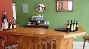 a room with a counter with bottles of wine at Latitud Catedral Apartamento in San Carlos de Bariloche