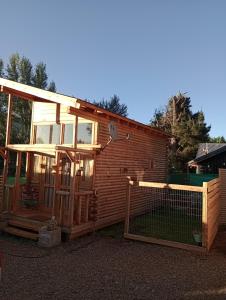 a house with a chicken coop in front of it at Mini Casa en el Sur in San Martín de los Andes