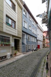 a cobblestone street next to a row of buildings at G&B MANSION in Istanbul