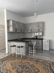a kitchen with a counter and stools in it at Guest house Simiram in Cholpon-Ata +38 photos