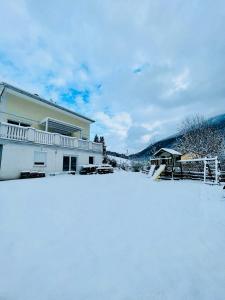 a house with snow in front of it at Tanjas Haus am Mondsee in Innerschwand