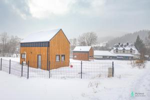 a barn in a field with snow on the ground at Dom w Starej Morawie, MyWeekpl in #N/A