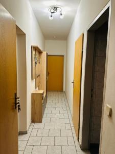 a hallway with yellow doors and a tile floor at Apartment Dolina 8a Kärnten KLagenfurt 