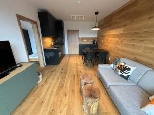 a living room with a couch and a table at ApartBene in Benecko