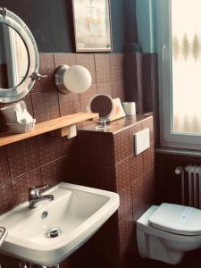 W łazience znajduje się umywalka, toaleta i lustro. w obiekcie beans parc hotel jade w mieście Wilhelmshaven