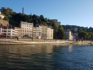 a body of water with buildings in the background at Le Couvent Saint Vincent in Lyon