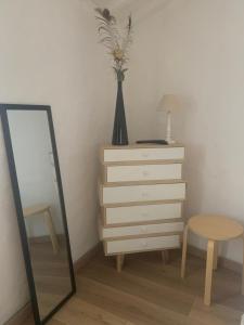 a bedroom with a dresser and a mirror and a table at La casetta di Seggiano in Seggiano