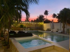 a swimming pool in a backyard at dusk at A L Y S S A Seaside Muine in Mui Ne