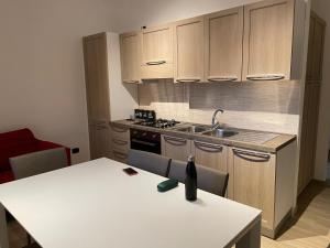 a kitchen with a white table with a bottle on it at MARTA'S APARTMENT ROCCARASO in Roccaraso +21 photos