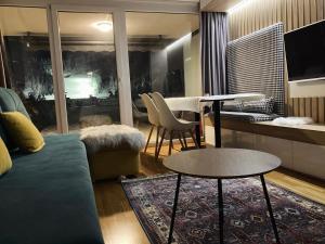 a living room with a couch and a table at Sarajevo 84 in Bjelašnica