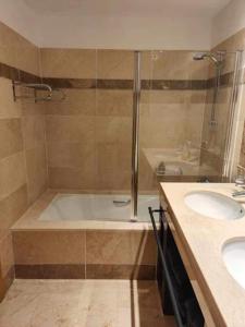 a bathroom with a shower and a tub and a sink at Jardines de Albaicin - La Aldorra in Estepona
