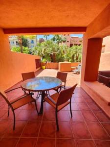 a patio with a table and chairs on a balcony at Jardines de Albaicin - La Aldorra in Estepona