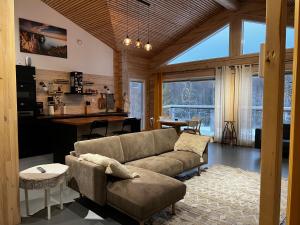 a living room with a couch and a table at Kiiski Home in Teijo