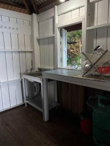 a kitchen with a counter and a table in a house at Hidden Viewpoint House in Mae Haad