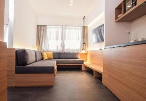 a living room with a couch and a window at Athens Lodge by Athens Prime Hotels in Athens