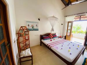 a bedroom with a large bed and a window at River Shadow Villa in Bentota