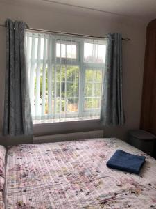 a bedroom with a bed and a large window at House in Hounslow