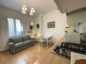 a kitchen and living room with a couch and a table at Sweet Home Bologna in Bologna