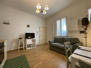 a living room with a couch and a table at Sweet Home Bologna in Bologna