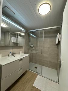 a bathroom with a shower and a sink at Steghorn in Leukerbad