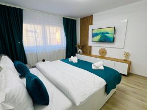 a bedroom with a large bed and a window at MarbleHome~Straja/Lupeni in Lupeni